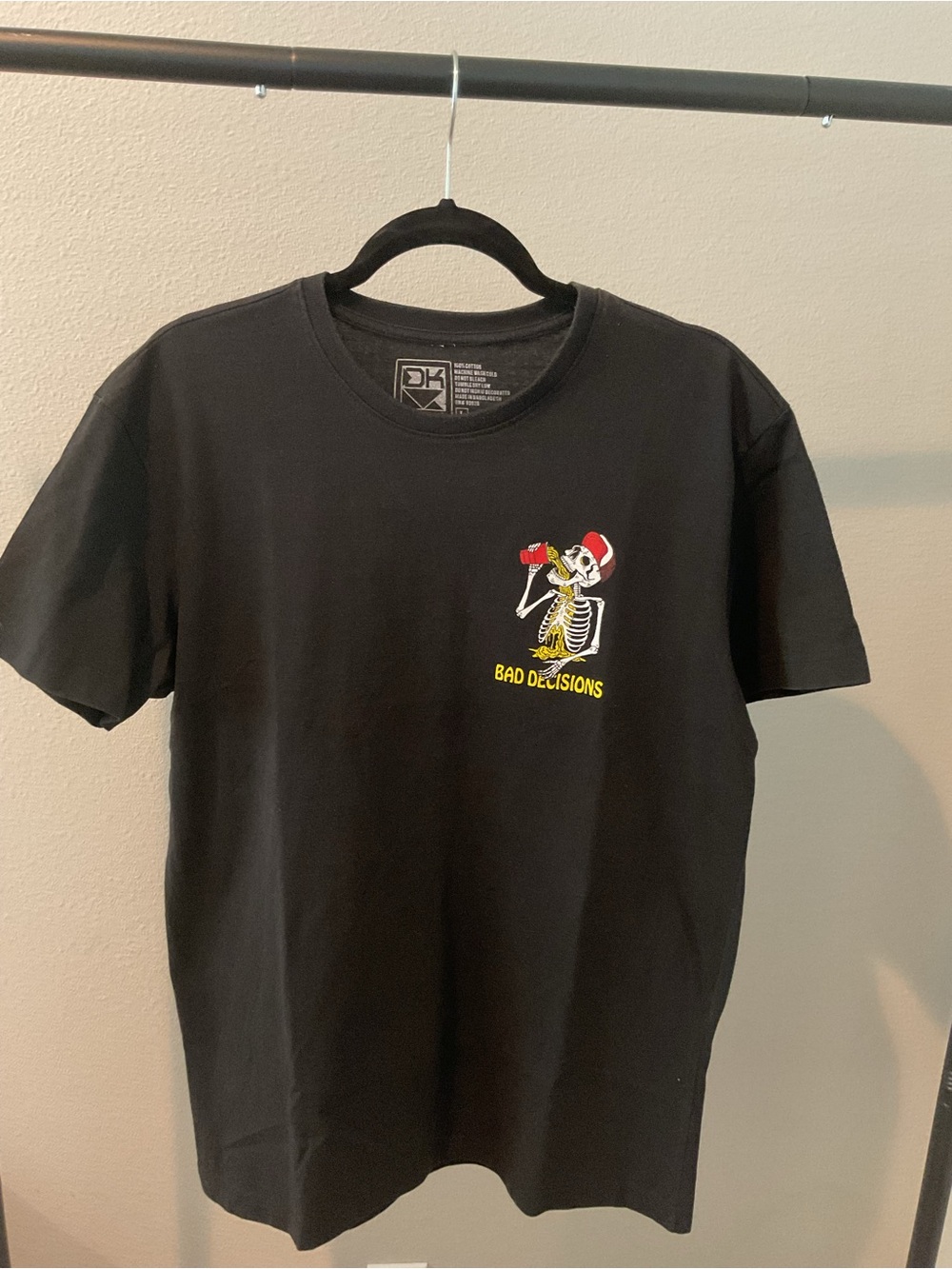Source Unknown Black Tee with Yellow 'Bad Decisions' Skeleton Graphic
